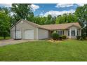 Attractive single-story home with a two-car garage and a well-manicured lawn at 3217 New Rutledge Nw Rd, Kennesaw, GA 30152