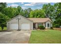 Lovely single-story home with a two-car garage and a basketball hoop in the driveway at 3217 New Rutledge Nw Rd, Kennesaw, GA 30152