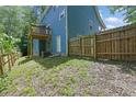 Home backyard featuring a wooden fence and access to a walkout basement at 4002 Laurel Bend Dr, Snellville, GA 30039