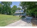 Landscaped home with a large front yard, concrete driveway and inviting front porch at 4002 Laurel Bend Dr, Snellville, GA 30039