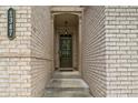 Close-up of a charming home entry, featuring a detailed brick facade and a welcoming glass-paneled door at 1347 Elderwood Way, Cumming, GA 30041