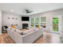 Inviting living room with a fireplace, large windows, and access to an outdoor deck for relaxed living at 1347 Elderwood Way, Cumming, GA 30041