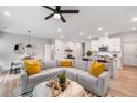 Bright open-concept living area with modern decor, stainless steel appliances, and a comfortable sectional sofa at 1347 Elderwood Way, Cumming, GA 30041