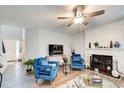 Inviting living room with a fireplace, blue armchairs, and modern decor at 2121 Silva Ct, Conley, GA 30288
