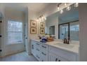 Bright bathroom features double sinks, vanity with drawers, and a large mirror over a stone countertop at 220 Nicklaus Cir, Social Circle, GA 30025