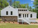 Inviting home with stone accents, white siding, large windows, and a welcoming front porch at 2920 Alberta Dr, Marietta, GA 30062