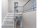 Bright staircase with white steps and black metal railing at 5857 Earlwane Dr, Lithonia, GA 30058