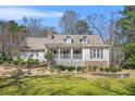 Charming single-Gathering home with stone accents, dormer windows and a beautifully landscaped front yard at 65 Deer Run Ln, Mcdonough, GA 30252