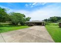 Wide driveway leading to a quaint single story brick home with lush green lawn at 87 Virgil Sw St, Mableton, GA 30126