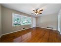 Bright living room featuring hardwood floors, a ceiling fan, and large windows at 87 Virgil Sw St, Mableton, GA 30126