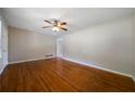Spacious living room with gleaming hardwood floors, ceiling fan, and neutral paint at 87 Virgil Sw St, Mableton, GA 30126