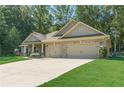 Well-maintained single-story home with a spacious driveway and manicured front yard offers great curb appeal at 150 Whitworth Dr, Locust Grove, GA 30248