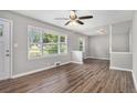 Bright and airy living room with hardwood floors, large windows, neutral paint, and modern ceiling fan at 1879 Rosewood Rd, Decatur, GA 30032