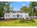 Charming condo building with well-maintained landscaping, mature trees, and inviting entrance showcasing curb appeal and community charm at 228 Olympic Pl # 47, Decatur, GA 30030