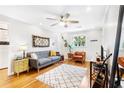 Light-filled living room with modern decor, hardwood floors, a ceiling fan, and a cozy seating area creates a welcoming space at 228 Olympic Pl # 47, Decatur, GA 30030