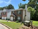 Brick and siding two-story house with a well-manicured lawn, chimney, and an attached garage at 3949 Riverside Pkwy, Decatur, GA 30034