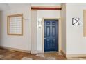 Inviting condo entryway features a blue door, travertine floors, and a glass block window at 10 Perimeter Summit Ne Blvd # 4243, Brookhaven, GA 30319
