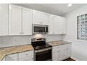 Modern kitchen featuring white cabinets, stainless appliances, and granite countertops at 10 Perimeter Summit Ne Blvd # 4243, Brookhaven, GA 30319