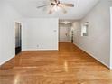 Spacious room with hardwood floors, neutral colors and plenty of natural light at 145 Shadowbrook Trce, Covington, GA 30016