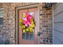 Close-up of a cheerful front door adorned with a bright wreath and smart lock at 2534 Norwood Park Xing, Atlanta, GA 30340