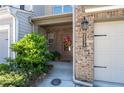 Exterior view of townhome featuring a well-maintained yard and attached garage at 2534 Norwood Park Xing, Atlanta, GA 30340