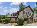 Elegant brick townhome with arched windows, manicured shrubs and stone steps at 3113 Lenox Ne Rd # 6, Atlanta, GA 30324