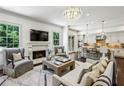 Bright living room featuring a fireplace, hardwood floors, and an open layout to the kitchen at 3113 Lenox Ne Rd # 6, Atlanta, GA 30324