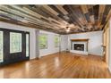 Inviting living room with a unique wood ceiling, fireplace, and hardwood floors at 2170 Jonquil Ct, Canton, GA 30115