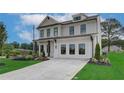 Charming two-story home with a well-maintained lawn, tasteful landscaping, and modern architectural details at 2700 Westgate Park Dr, Loganville, GA 30052