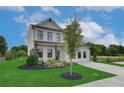 Inviting two-story home featuring lush green grass, artful landscaping, and a wide, paved driveway at 2700 Westgate Park Dr, Loganville, GA 30052