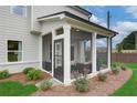 Cozy screened porch with comfortable seating, offering an ideal outdoor relaxation space at 2700 Westgate Park Dr, Loganville, GA 30052