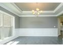 Dining area with gray walls, white trim, hardwood floors, and modern chandelier at 3018 Old Covington Rd, Covington, GA 30014