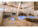 Unique indoor pool featuring a waterfall, hot tub, and wood accents at 128 Graybrook Ct, Grayson, GA 30017