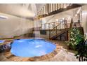 Beautiful indoor pool area with waterfall, stone accents, and upper-level seating at 128 Graybrook Ct, Grayson, GA 30017