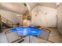 Indoor pool area boasting a waterfall feature and upstairs recreation area at 128 Graybrook Ct, Grayson, GA 30017