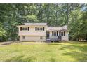 Charming two-story home with a well-maintained lawn and mature trees, providing a serene and inviting curb appeal at 155 S South Meadowcliff Cir, Carrollton, GA 30116