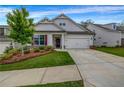 Inviting home with gray siding, a well-kept lawn, and a two-car garage at 178 Sunshower Rdg, Canton, GA 30114