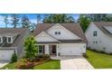Charming home with white siding, a well-manicured lawn, and a two-car garage at 178 Sunshower Rdg, Canton, GA 30114
