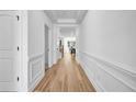 Bright hallway with wood floors, white trim, and an open view into other rooms at 178 Sunshower Rdg, Canton, GA 30114