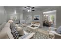 Cozy living room featuring stylish furniture, a patterned rug, and an open view into the dining area at 23 Club Dr, Locust Grove, GA 30248