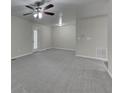 Bright living room features new carpet and neutral walls providing a blank slate to make the room your own at 23 Club Dr, Locust Grove, GA 30248