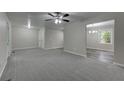 Spacious living room flows into the dining area that features hardwood floors and plenty of natural light at 23 Club Dr, Locust Grove, GA 30248