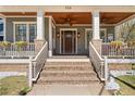 Inviting front porch with brick stairs, white railings, and decorative flower boxes, leading to the front door at 958 Austin Ne Ave, Atlanta, GA 30307