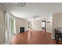 Inviting living room featuring a cozy fireplace, wood flooring, and sliding glass doors to the outside at 1371 Keys Lake Ne Dr, Brookhaven, GA 30319