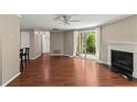 Open living room with fireplace, wood floors, and breakfast bar seating at 1371 Keys Lake Ne Dr, Brookhaven, GA 30319