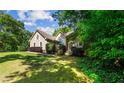 Beautiful home exterior with lush landscaping, offering great curb appeal at 1694 Peachcrest Ct, Lawrenceville, GA 30043