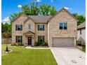 Charming two-story brick home with a manicured lawn and attached two car garage at 4814 Sultana Sw Way, Atlanta, GA 30331
