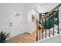 Bright and airy foyer featuring beautiful hardwood floors and staircase with wrought iron spindles at 4814 Sultana Sw Way, Atlanta, GA 30331