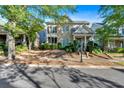 Beautiful two-story home boasts a stone facade, a covered porch, and mature trees at 4845 Backbay St, Suwanee, GA 30024