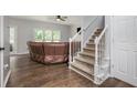 Cozy living room featuring hardwood floors, staircase and a comfortable leather couch at 2482 Windchase Dr, Buford, GA 30518